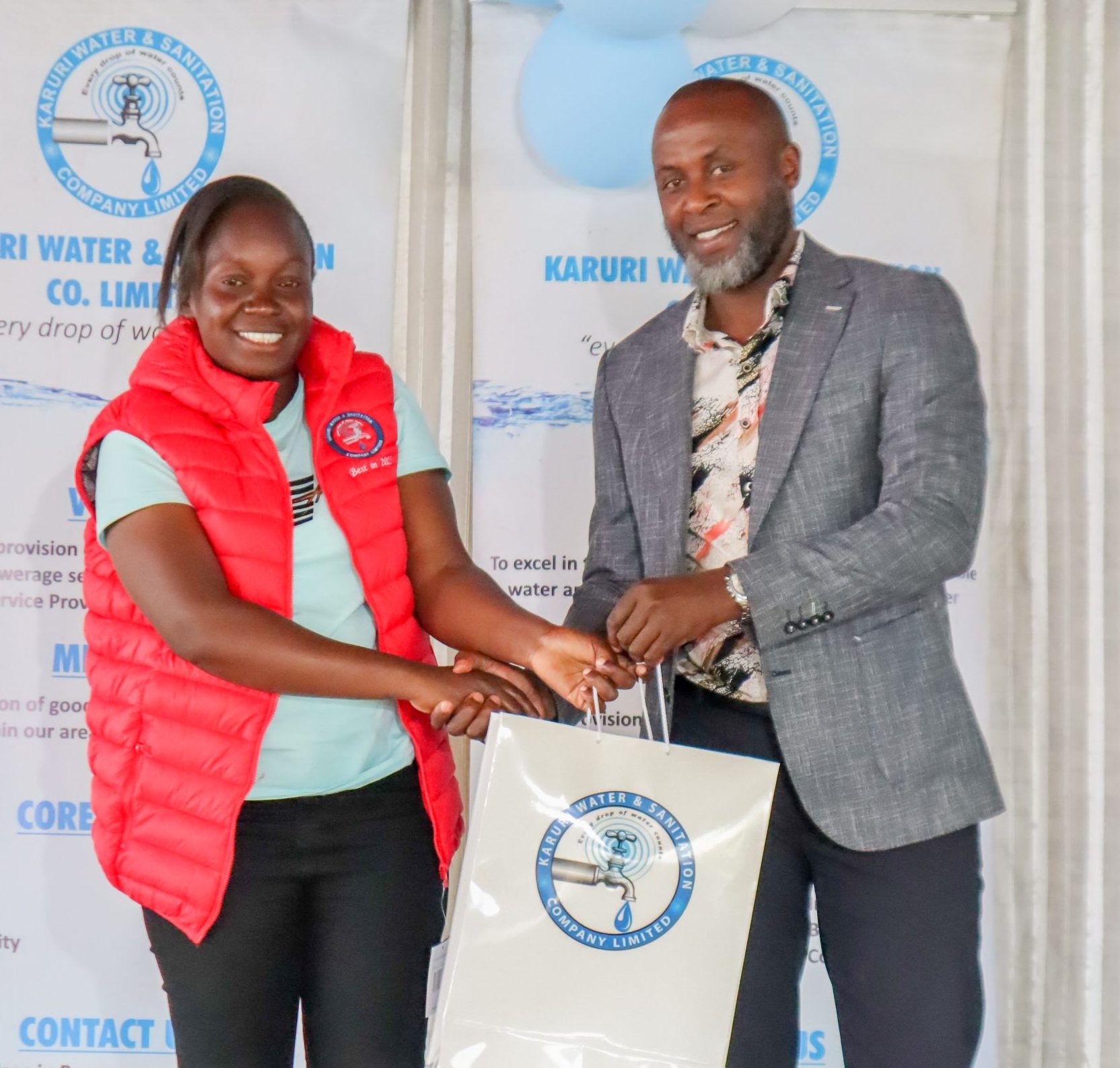 Margret Mutanda receiving Employee of the Year from the Managing Director